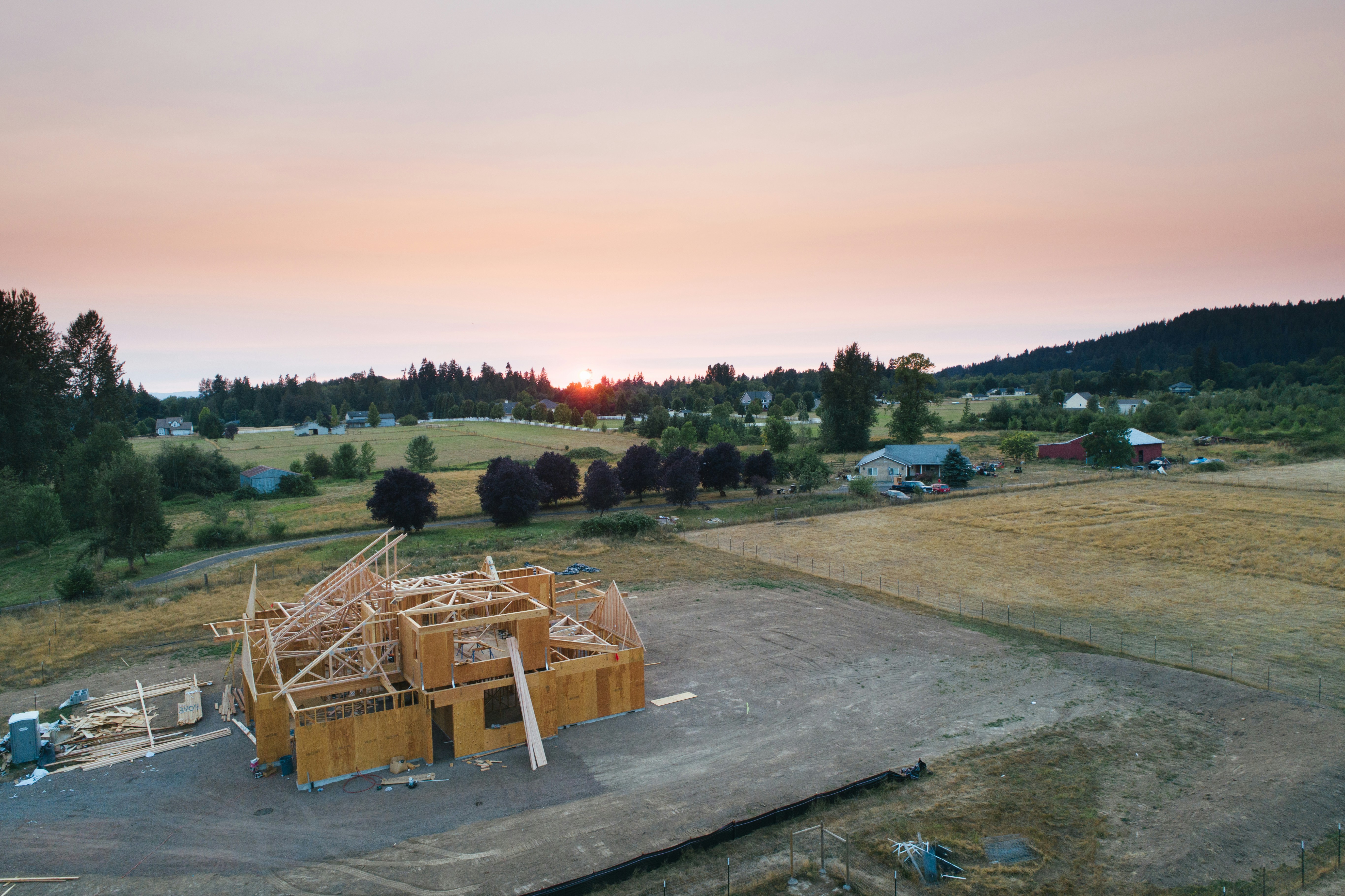 House construction in progress at sunset