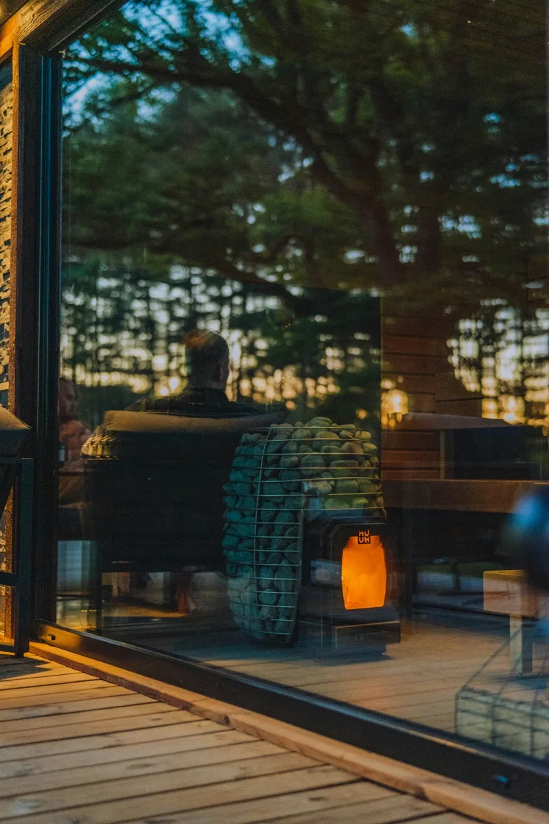 Vacation rental cabin with hot tub on wooden deck surrounded by trees